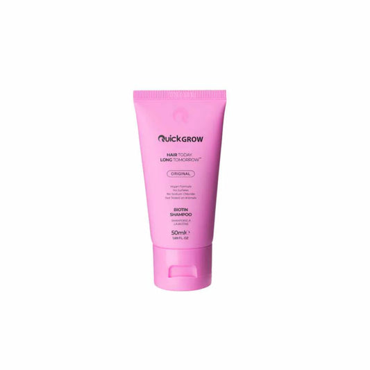 Pink shampoo bottle with 'Quickgrow' branding on a white background